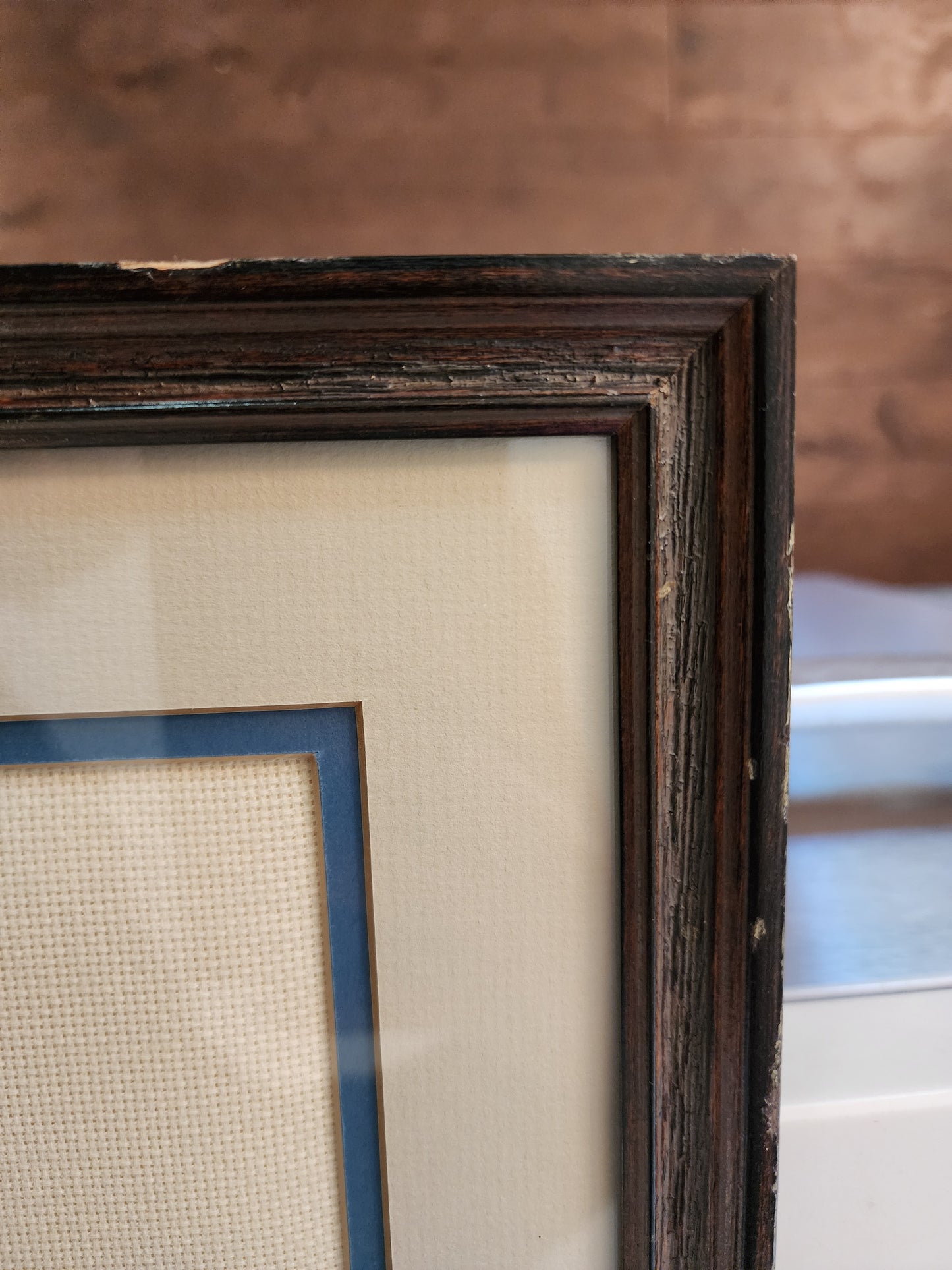 Charming framed needlepoint (or cross-stitch) artwork capturing a classic equestrian scene, signed and dated 1985.