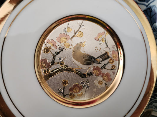 The Art of Chokin porcelain plate, featuring a detailed bird and cherry blossoms scene.