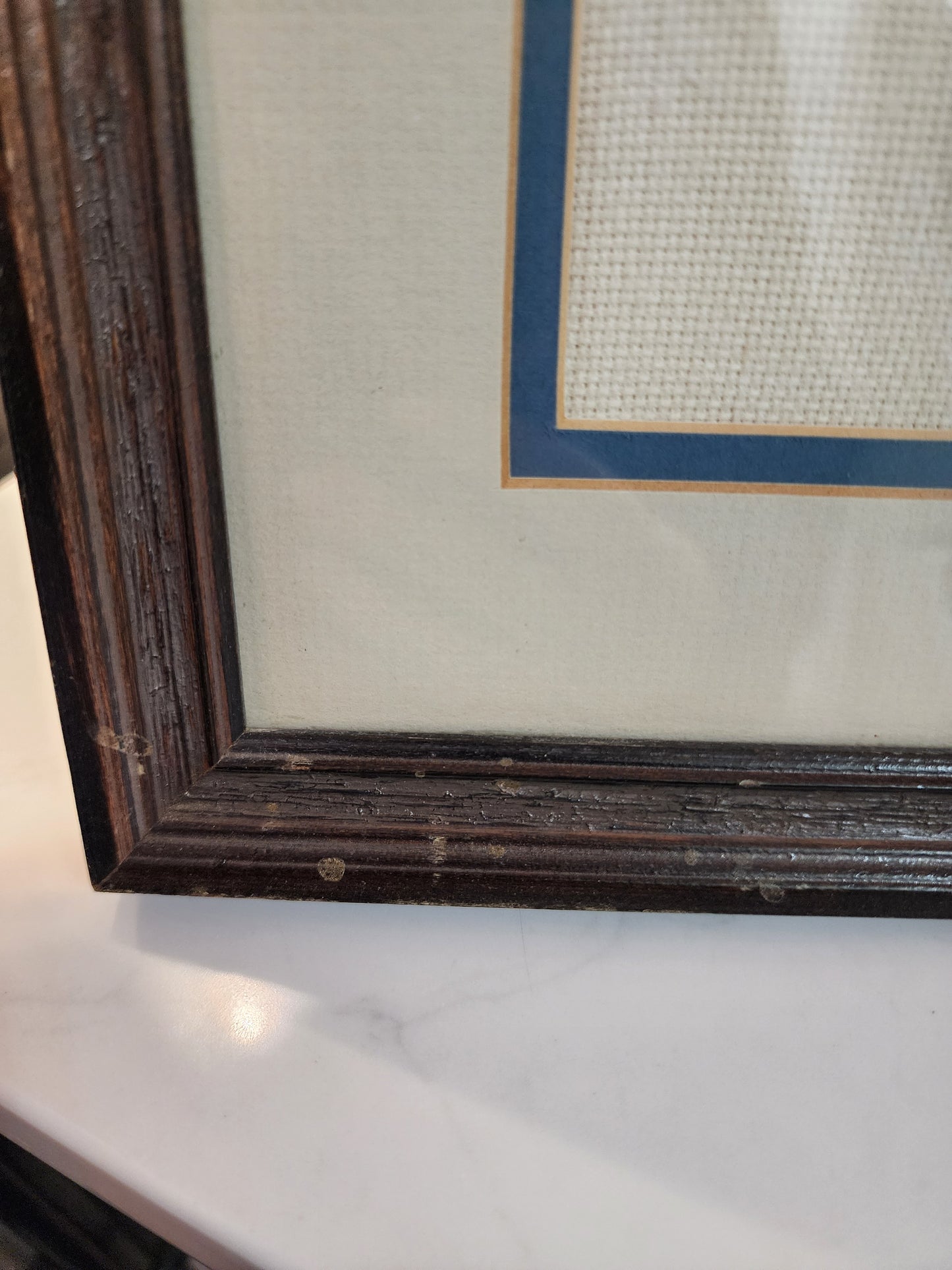 Charming framed needlepoint (or cross-stitch) artwork capturing a classic equestrian scene, signed and dated 1985.